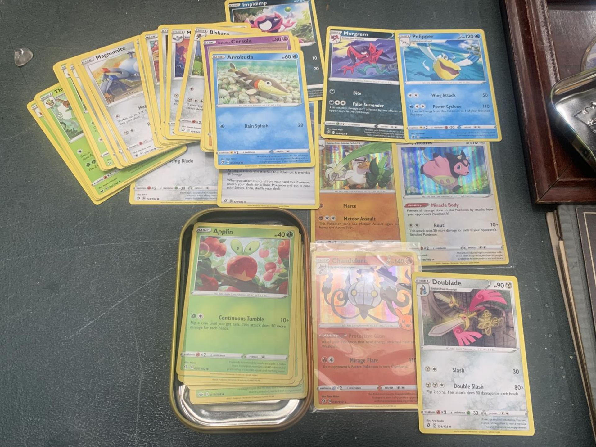 A POKEMON TIN WITH CARDS TO INCLUDE HOLOS, ETC