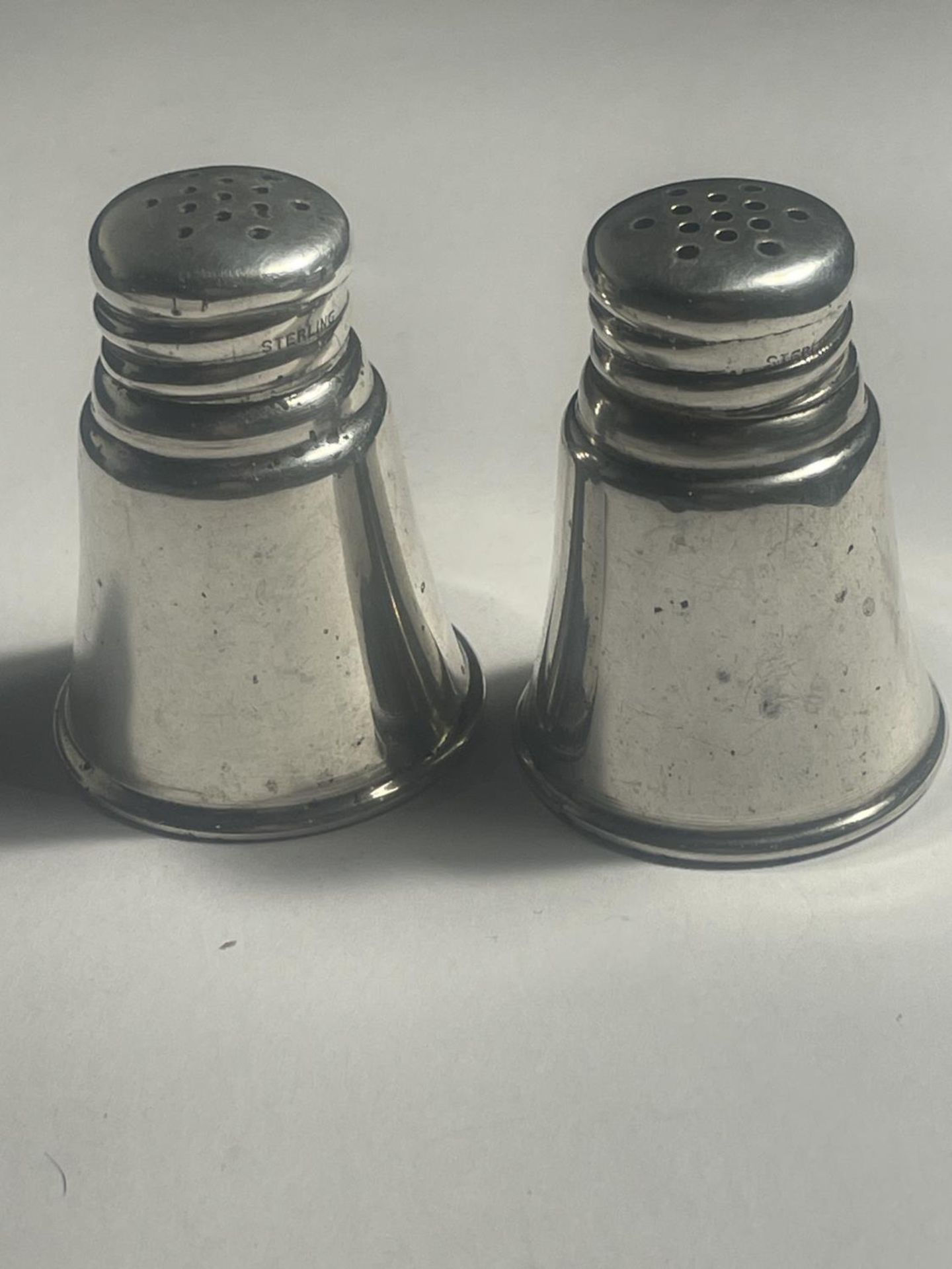 A PAIR OF MARKED STERLING SILVER CRUETS