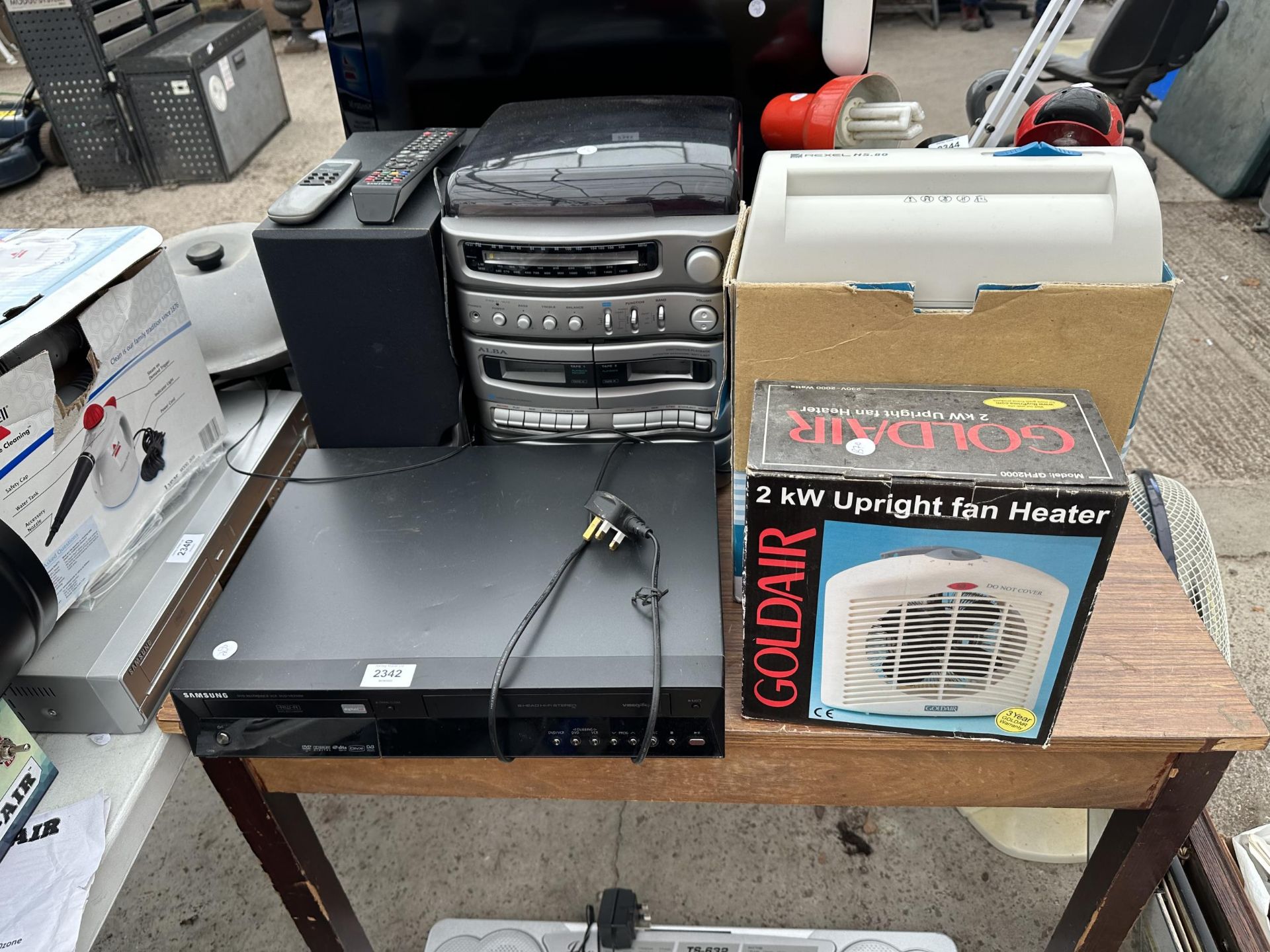 AN ASSORTMENT OF ITEMS TO INCLUDE A SAMSUNG VHS/DVD PLAYER, A HEATER AND A STEREO SYSTEM ETC