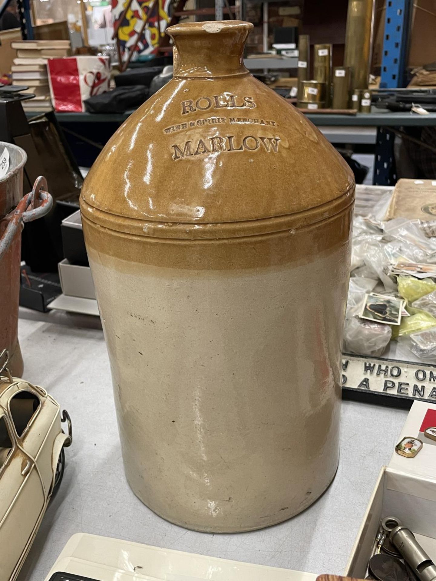 A DOULTON AND CO STONEWARE FLAGON STAMPED 'ROLLS WINE AND SPIRIT MERCHANT, MARLOW, HEIGHT APPROX