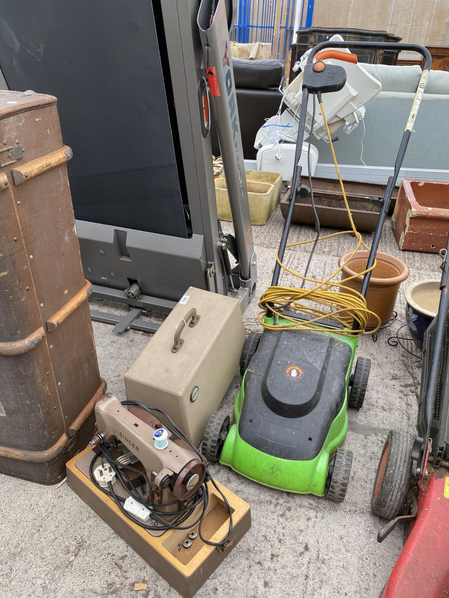 AN ELECTRIC SINGER SEWING MACHINE AND AN ELECTRIC LAWN MOWER