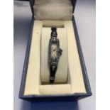 A SILVER ART DECO WRIST WATCH IN A PRESENTATION BOX SEEN WORKING BUT NO WARRANTY