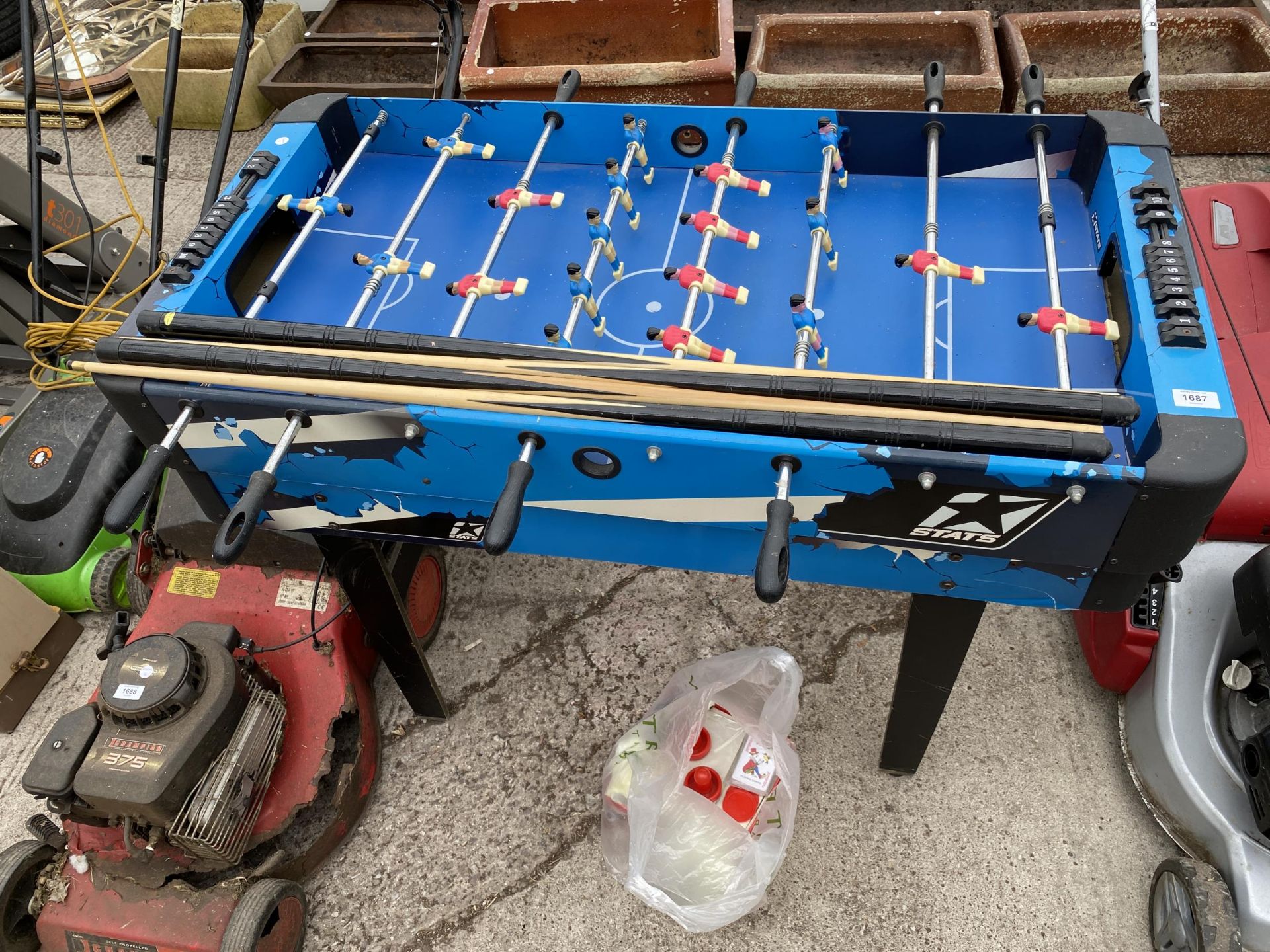 A CHILDS MULTIGAMES TABLE WITH ACCESORIES