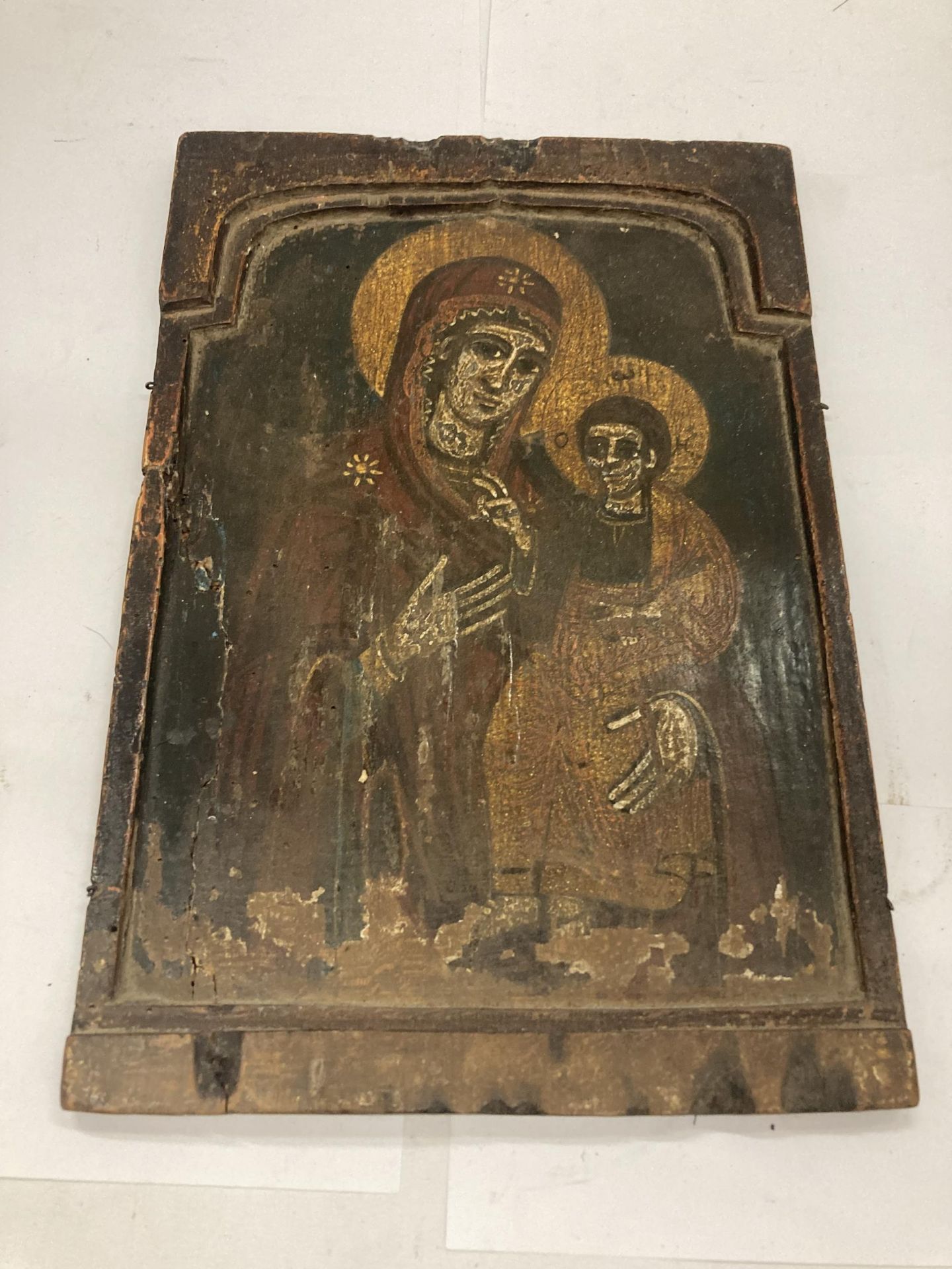 A 19TH CENTURY HAND PAINTED ICON OF THE MADONNA AND CHILD