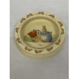 A ROYAL DOULTON BUNNYKINS DEEP IVORY GLAZED EARTHENWARE BABY PLATE "MEDICINE TIME" PRODUCED UNTIL