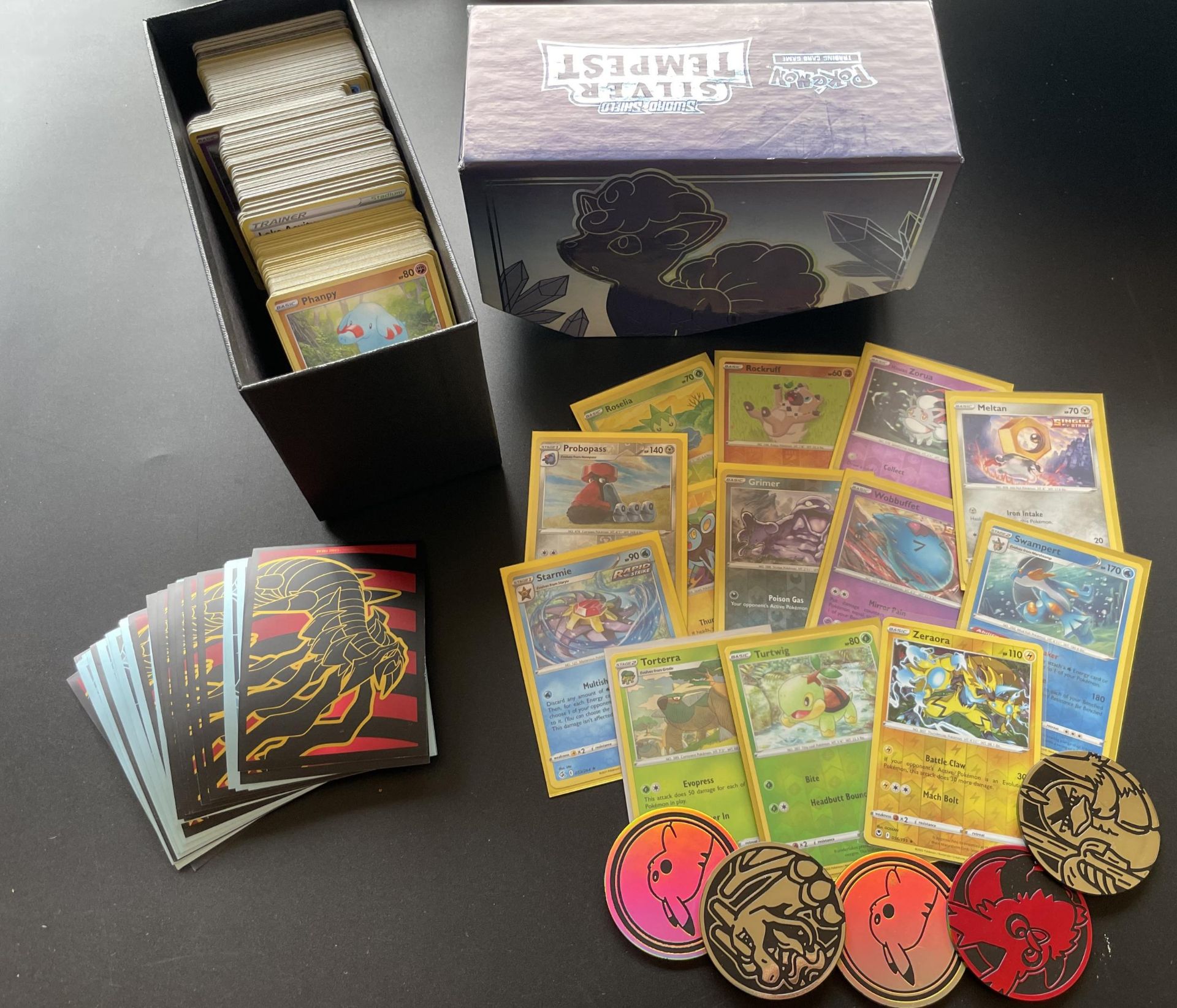 A TRAINER BOX OF ASSORTED POKEMON CARDS, GAME TOKENS, HOLOS ETC