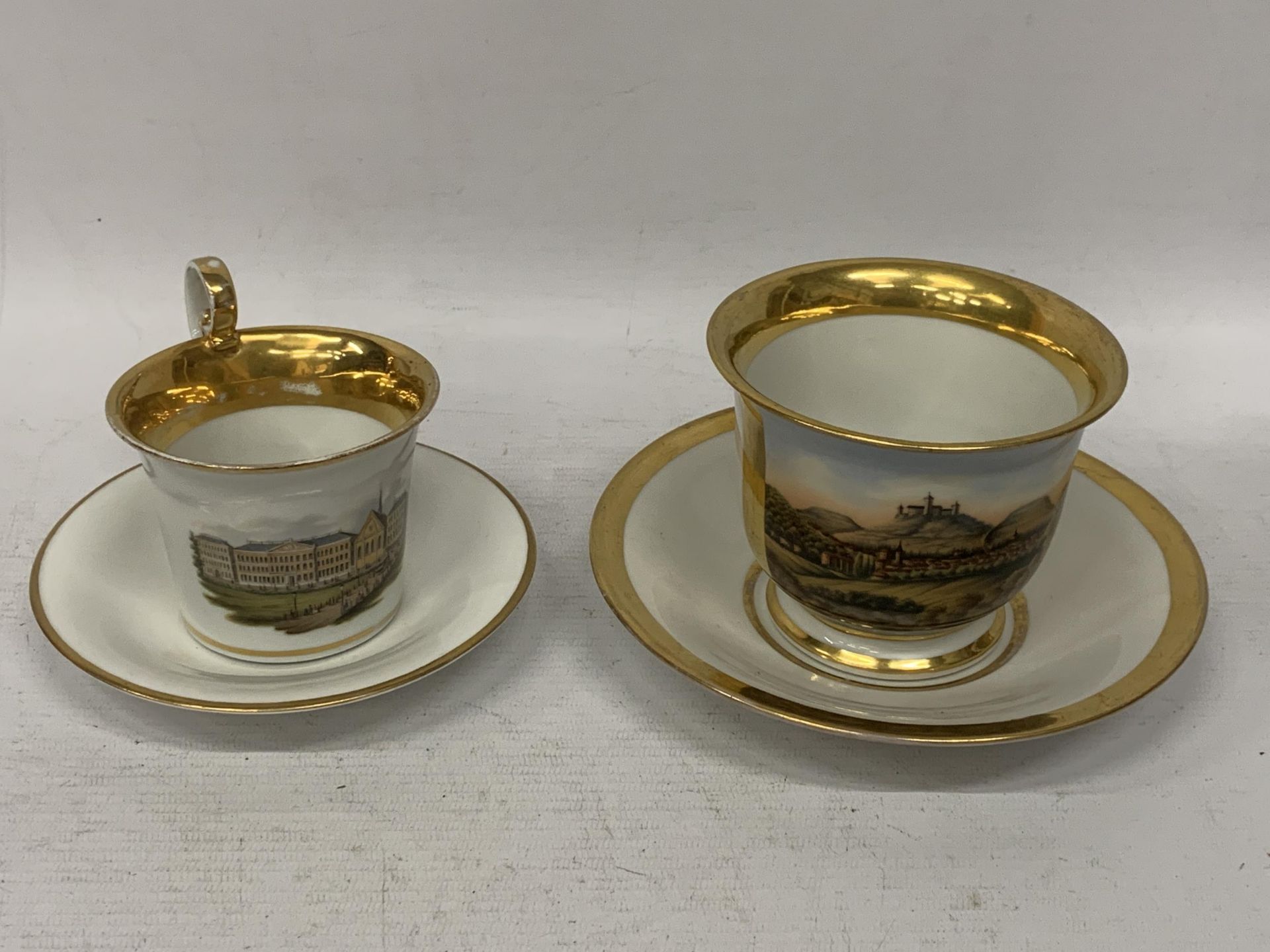 TWO CONTINENTAL HAND PAINTED PORCELAIN CUPS AND SAUCERS, BOTH WITH BLUE CONTINENTAL MARKS TO BASE