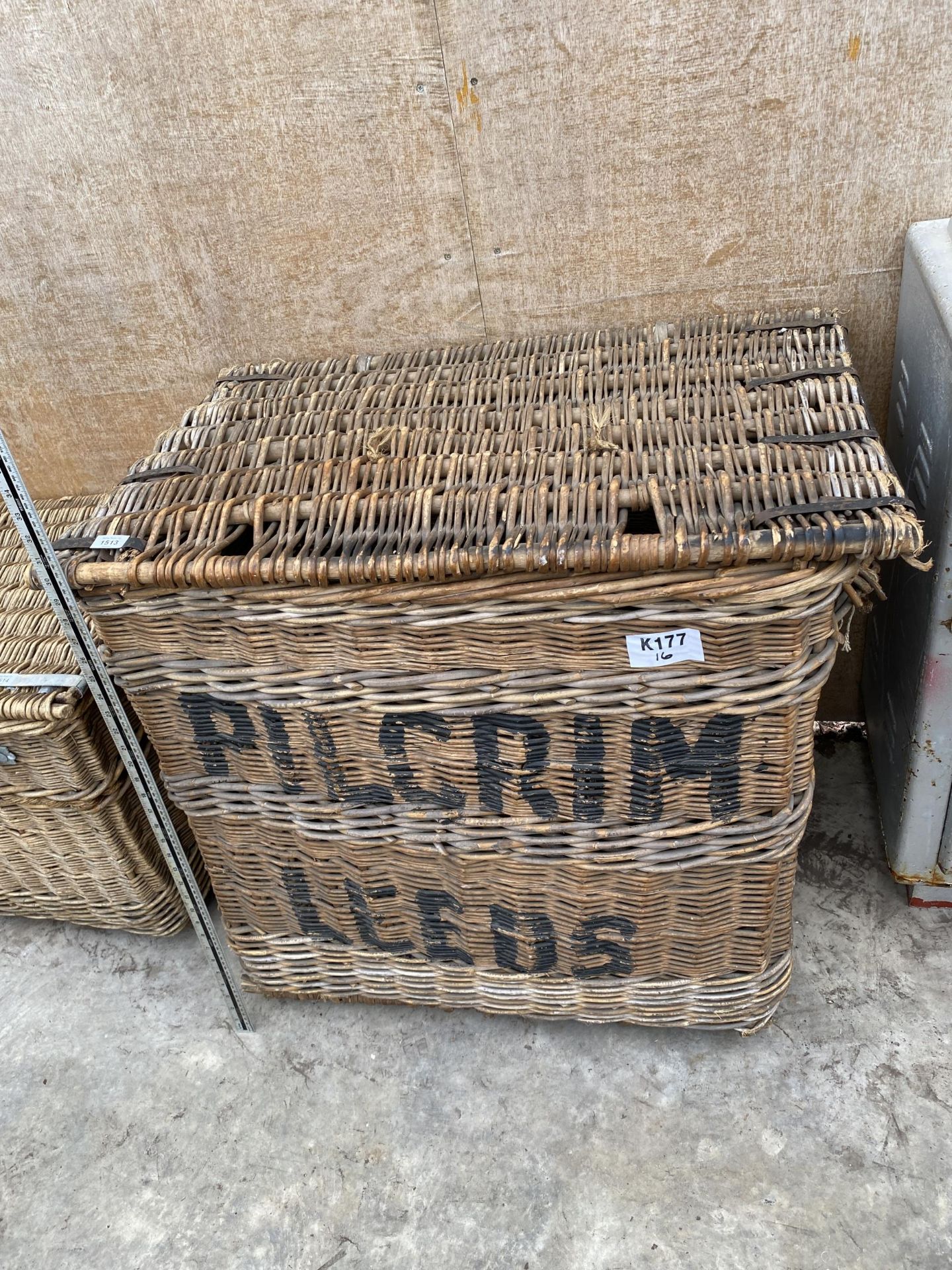 A LARGE ANTIQUE INDUSTRIAL MILL BASKET BASKET WITH HINGED LID AND METAL BANDING BEARING THE LABEL '