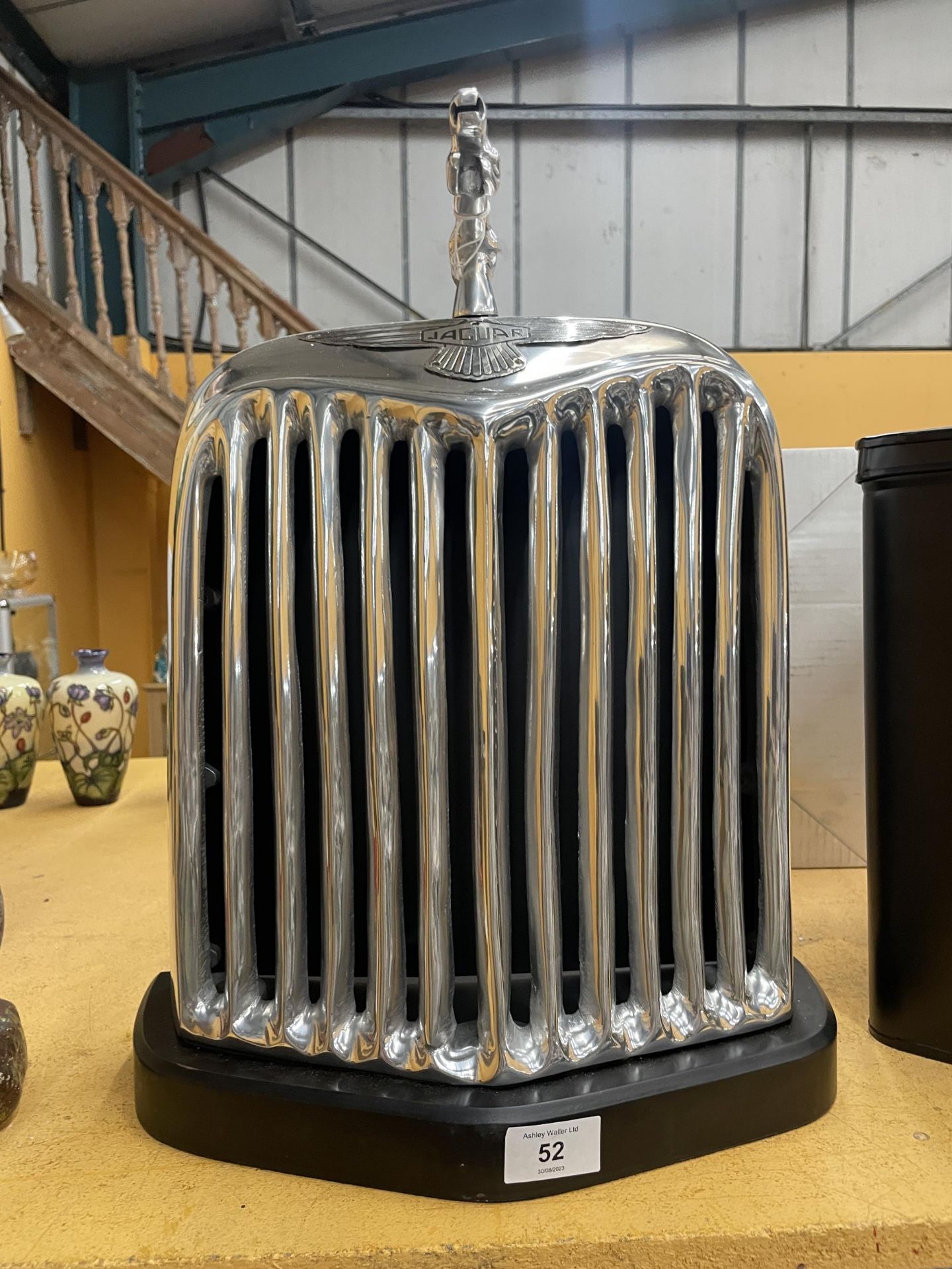 A CHROME STYLE JAGUAR RADIATOR ON BASE