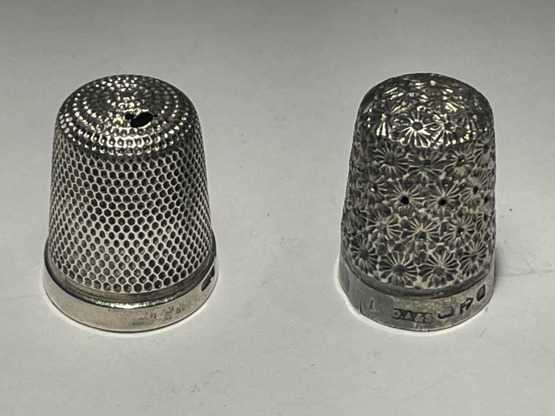 TWO MARKED SILVER THIMBLES