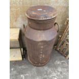 A VINTAGE MILK CHURN WITH LID BEARING AN INDISTINCT NAME