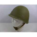 A GREEN PAINTED MILITARY HELMET WITH LEATHER LINING