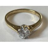 A 9 CARAT GOLD SOLITAIRE RING WITH A SOLITAIRE CUBIC ZIRCONIA STONE SIZE J
