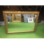 A HEAVY VINTAGE GILT FRAMED MIRROR 51CM X 69CM