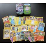 TWO TINS OF ASSORTED POKEMON CARDS, HOLOS ETC