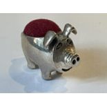 A SILVER PIG PIN CUSHION