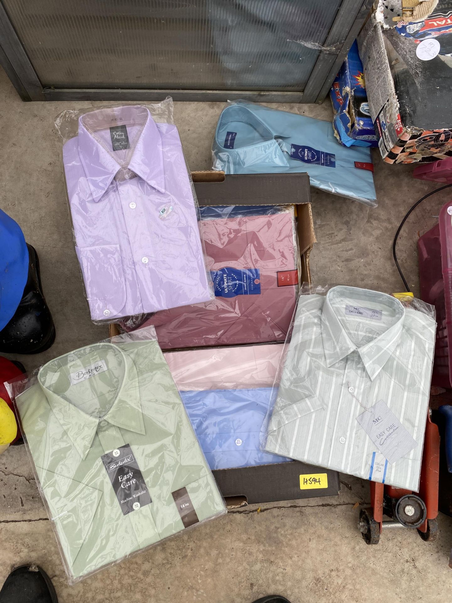 AN ASSORTMENT OF NEW AND PACKAGED MENS SHIRTS