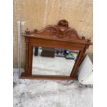 A DECORATIVE WOODEN FRAMED OVER MANTLE BEVELED EDGE WALL MIRROR