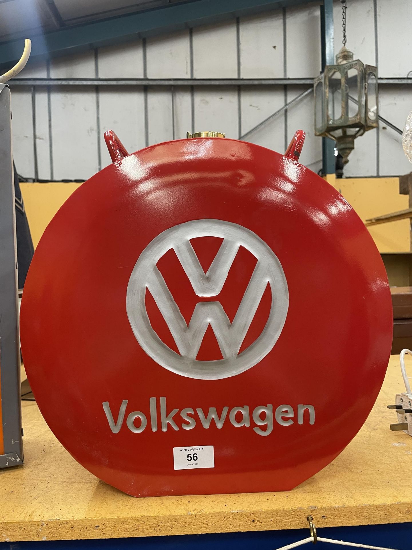 A RED VW PETROL CAN WITH BRASS TOP