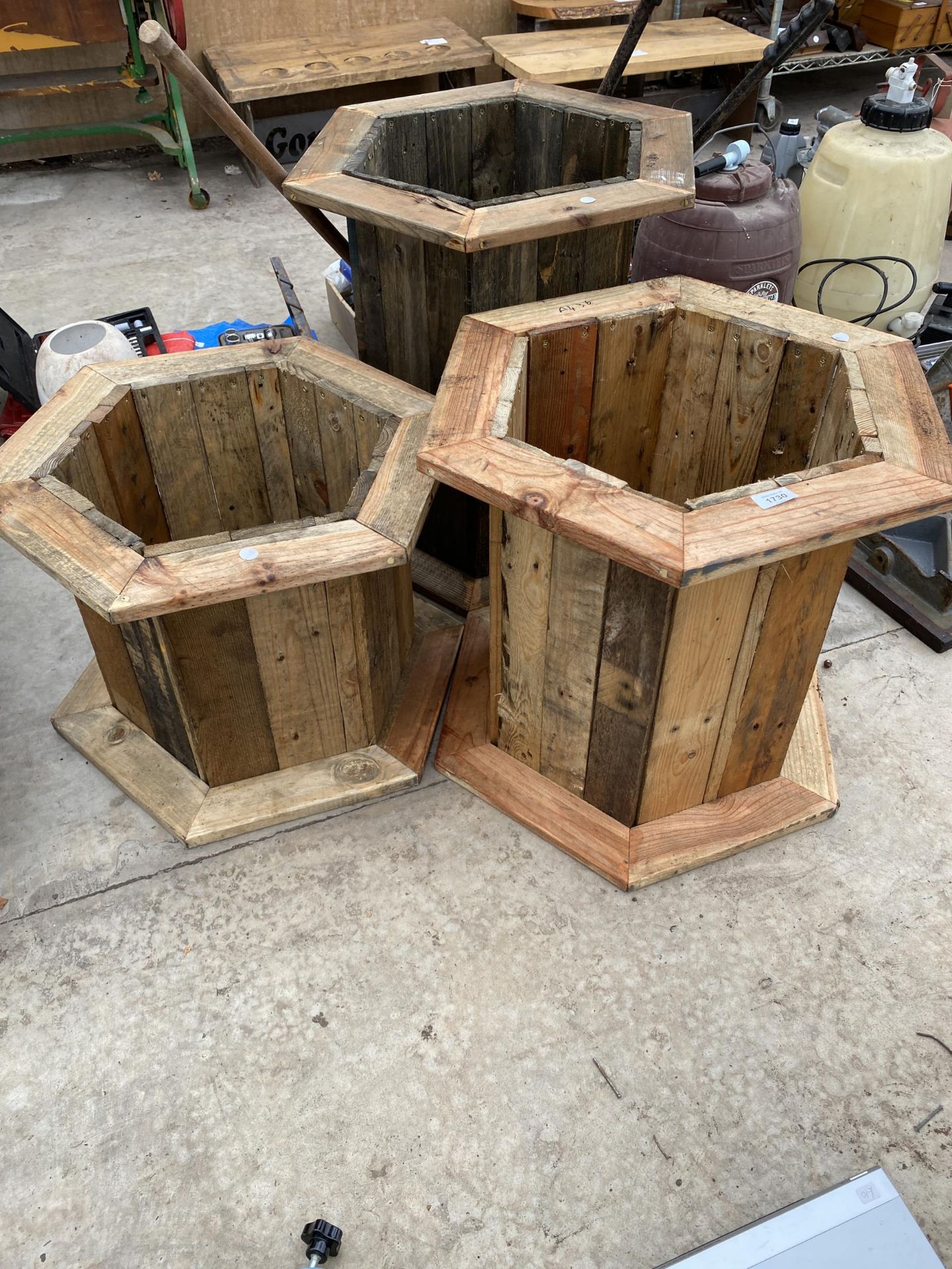 THREE GRADUATED WOODEN PLANTERS