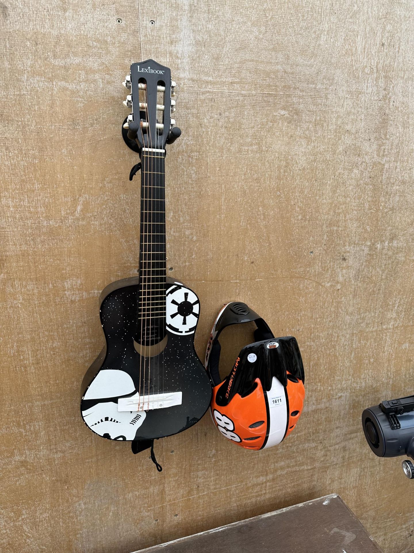 A LEXIBOOK CHILDS ACOUSTIC GUITAR AND A MOTOBIKE HELMET