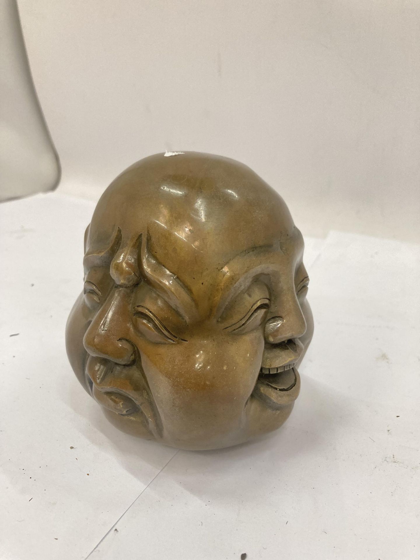 A BRASS FOUR FACED BUDDHA HEAD