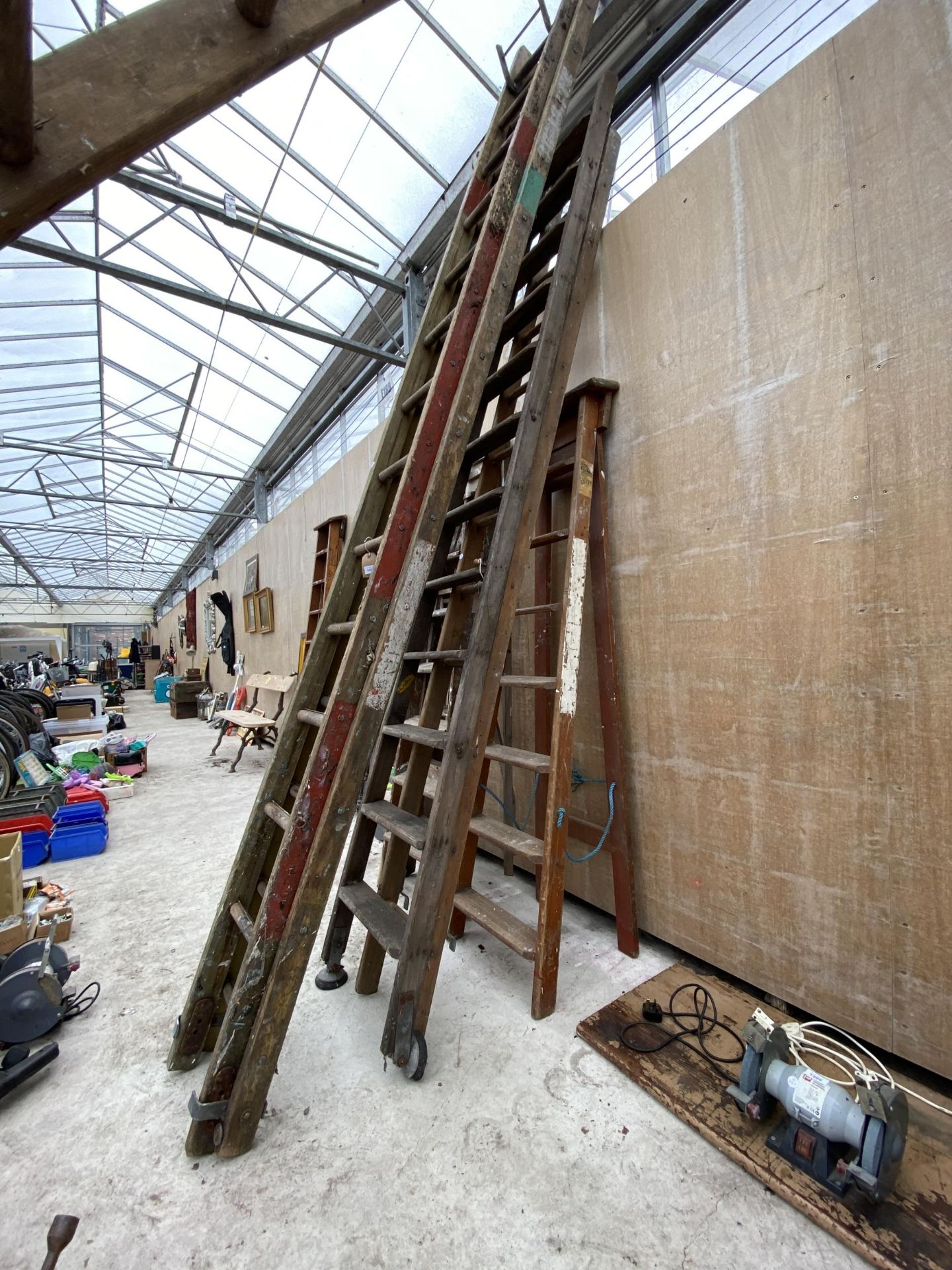 THREE VARIOUS VINTAGE WOODEN LADDERS TO INCLUDE A 7 RUNG WOODEN STEP LADDER