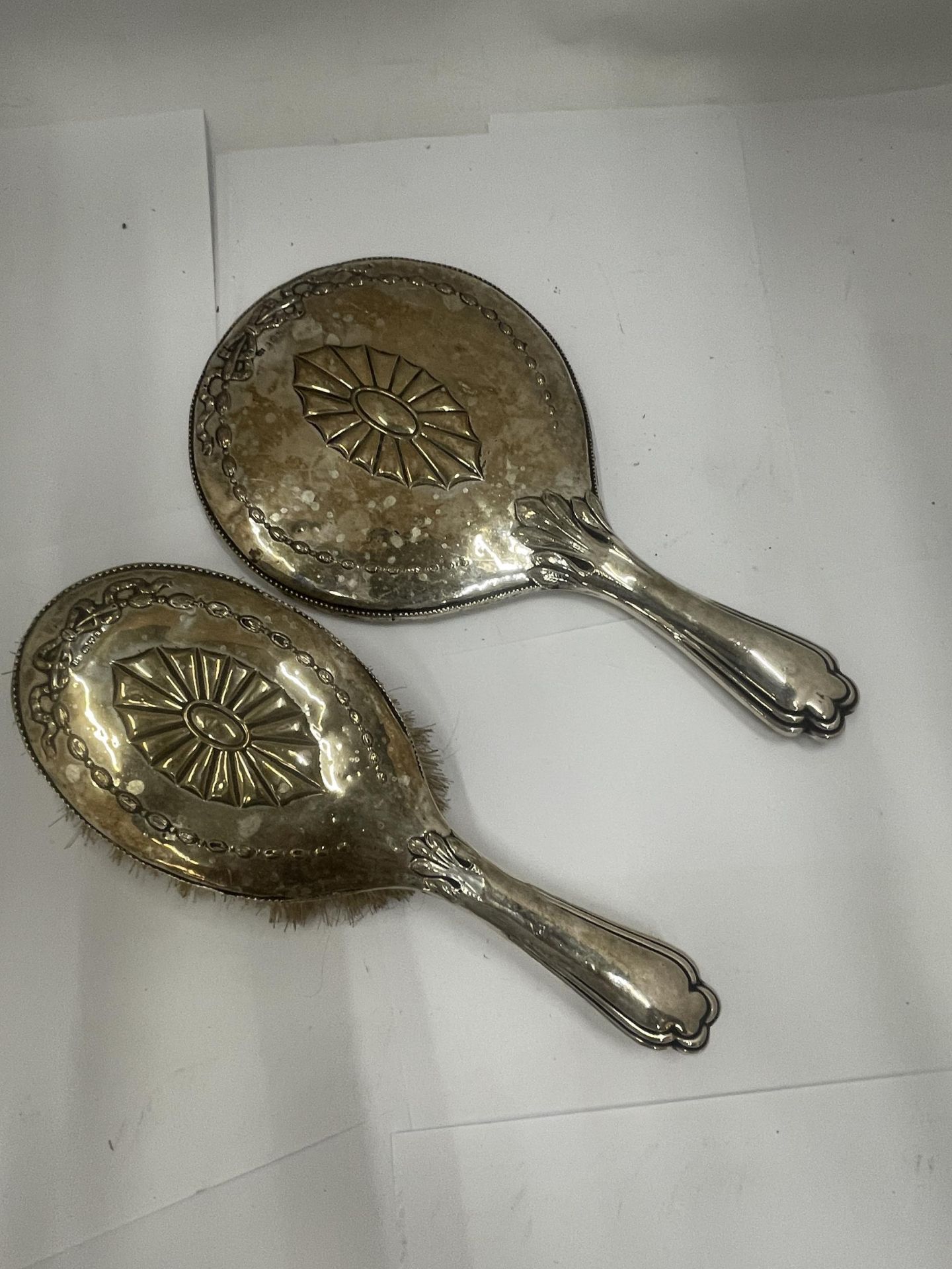 A PAIR OF EDWARDIAN SILVER DRESSING TABLE ITEMS - MIRROR AND BRUSH