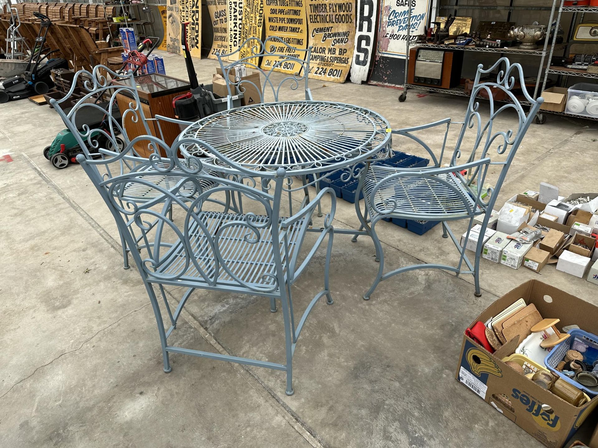 A METAL GARDEN TABLE AND FOUR FOLDING CARVER CHAIRS