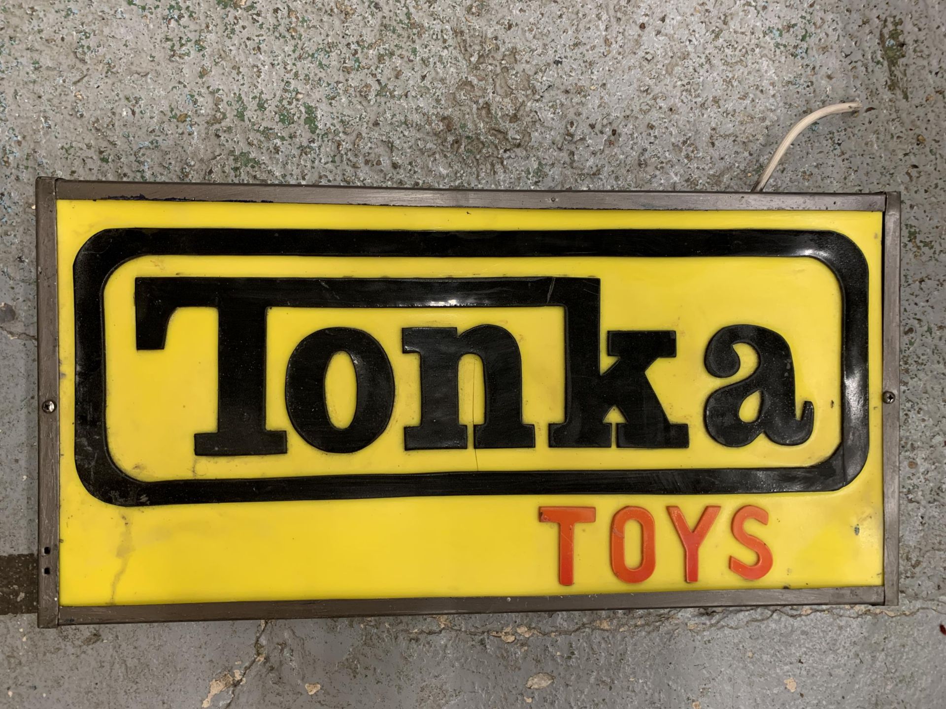 A TONKA TOYS ILLUMINATED LIGHT BOX SIGN 63CM X 32CM