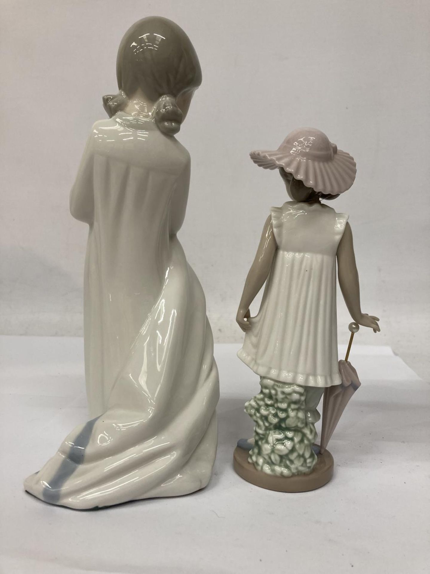 TWO NAO FIGURINES ONE HOLDING A BLANKET AND THE OTHER AN UMBRELLA - Image 2 of 7