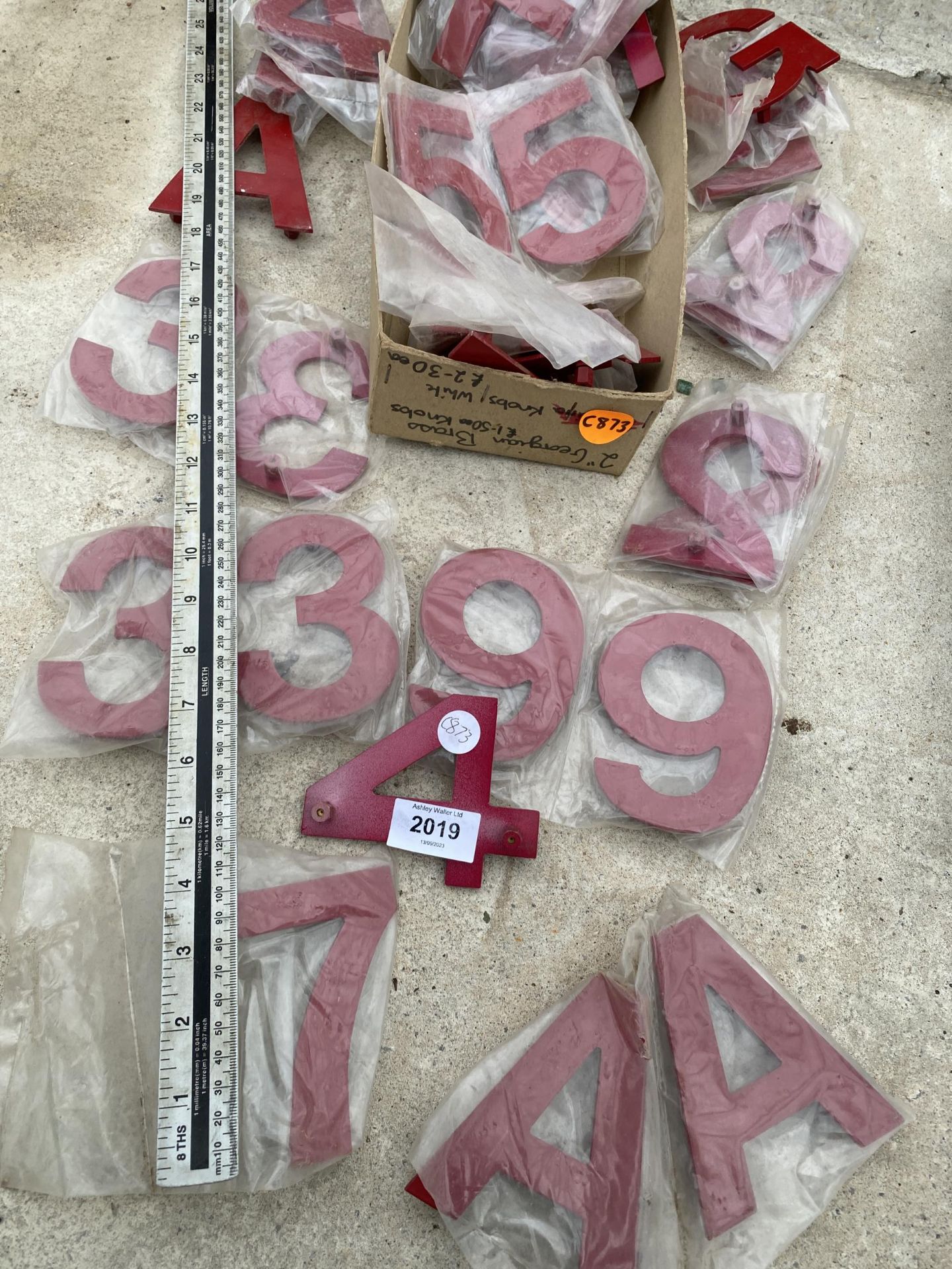 AN ASSORTMENT OF SIGN MAKING LETTERS AND NUMBERS