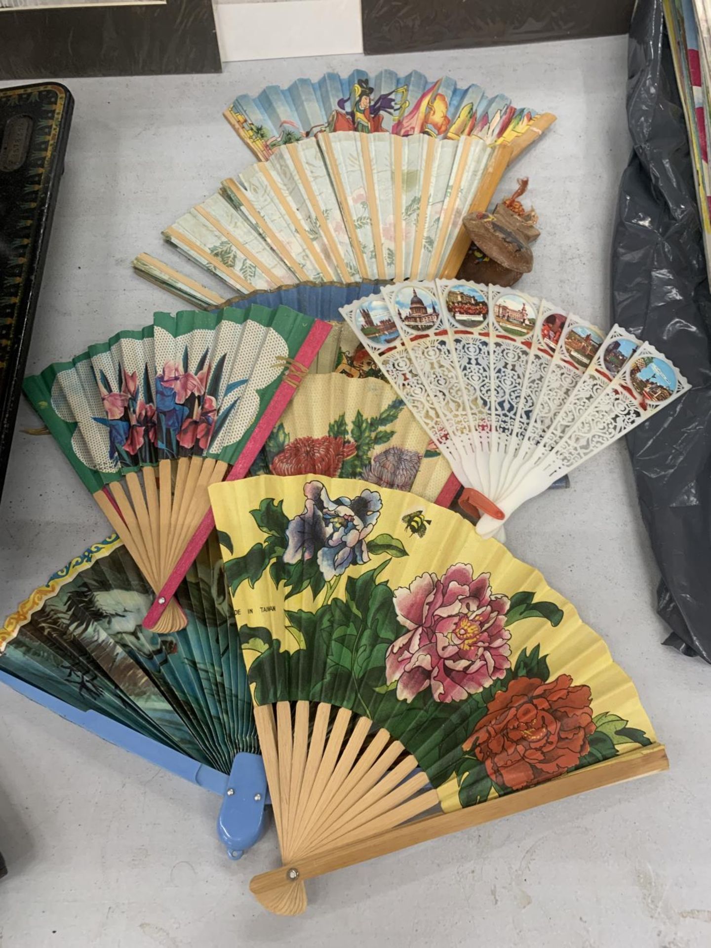 A COLLECTION OF PAPER SOUVENIR FANS