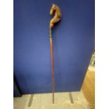 A VINTAGE WALKING/THUMB STICK WITH HORSE HEAD DESIGN