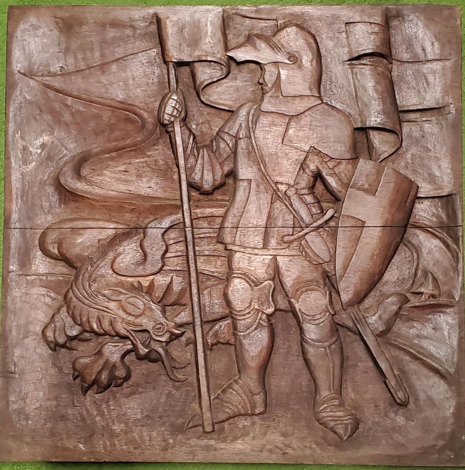 A CARVED WOODEN PLAQUE DEPICTING ST GEORGE AND THE DRAGON