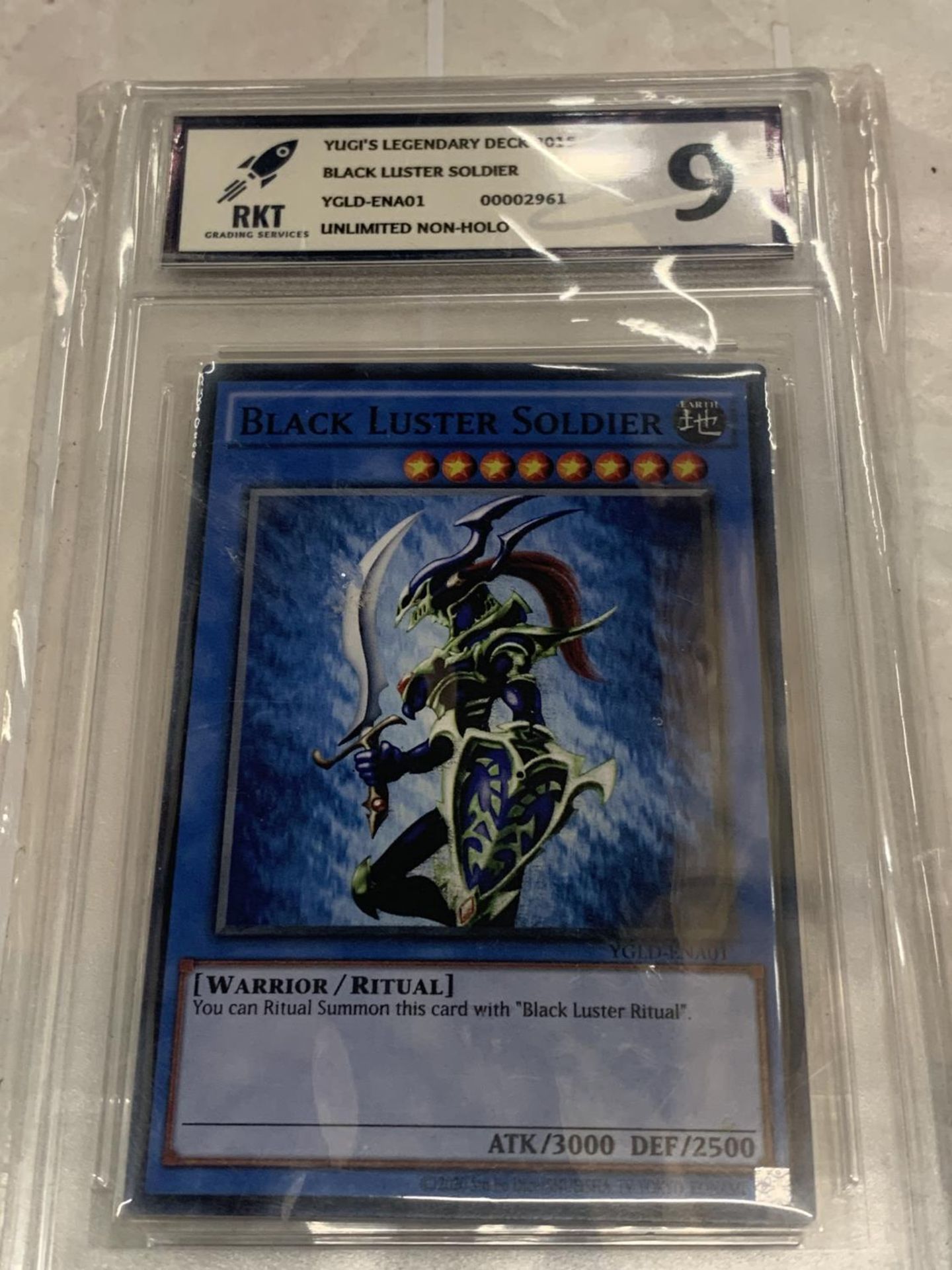 A YU-GI-OH GRADE 9/10 'BLACK LUSTER SOLDIER' TRADING CARD