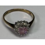 A 9 CARAT GOLD RING WITH A PINK HEART CENTRE STONE SURROUNDED BY CUBIC ZIRCONIAS SIZE O