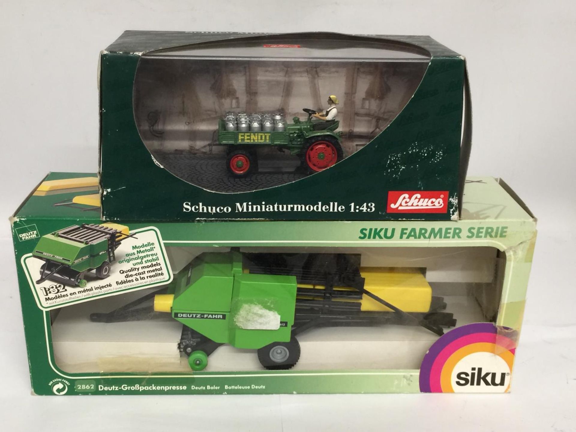 TWO BOXED FARM MODELS, A SCHUCO FENDT TRACTOR, 1/43 SCALE AND A SIKU DEUTZ BALER, 1/32 SCALE