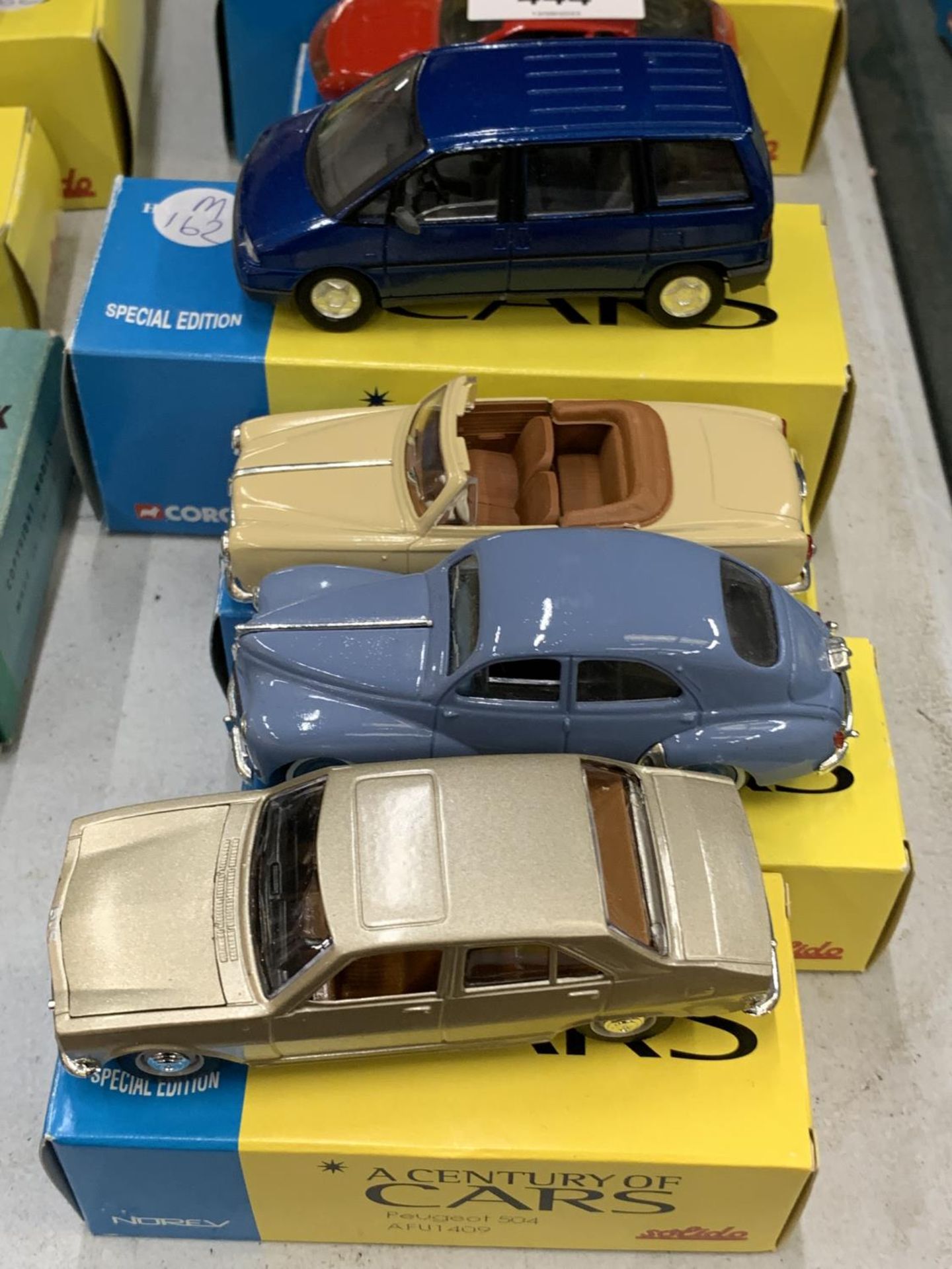 FOUR BOXED CORGI 'A CENTURY OF CARS' TO INCLUDE A PEUGEOT 504, 403 CABRIOLET, 806 AND 203