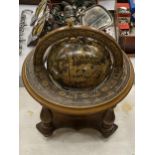 AN ITALIAN WOODEN ROTATING WORLD GLOBE WITH ASTROLOGICAL SIGNS TO THE SIDE, HEIGHT APPROX 23CM