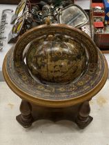 AN ITALIAN WOODEN ROTATING WORLD GLOBE WITH ASTROLOGICAL SIGNS TO THE SIDE, HEIGHT APPROX 23CM