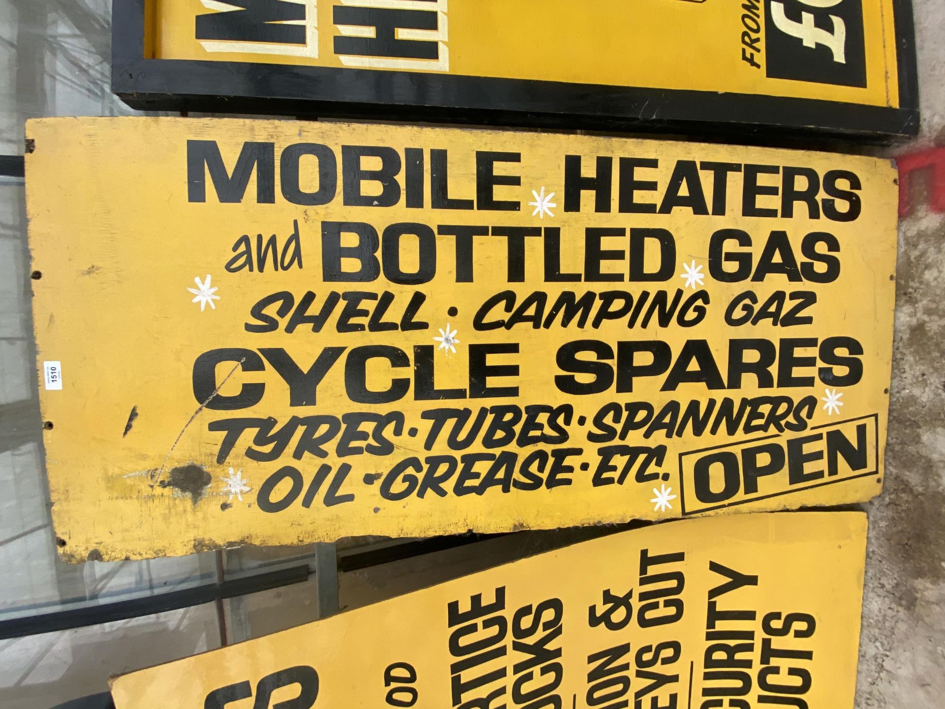 A WOODEN 'MOBILE HEATERS AND BOTTLED GAS' SIGN