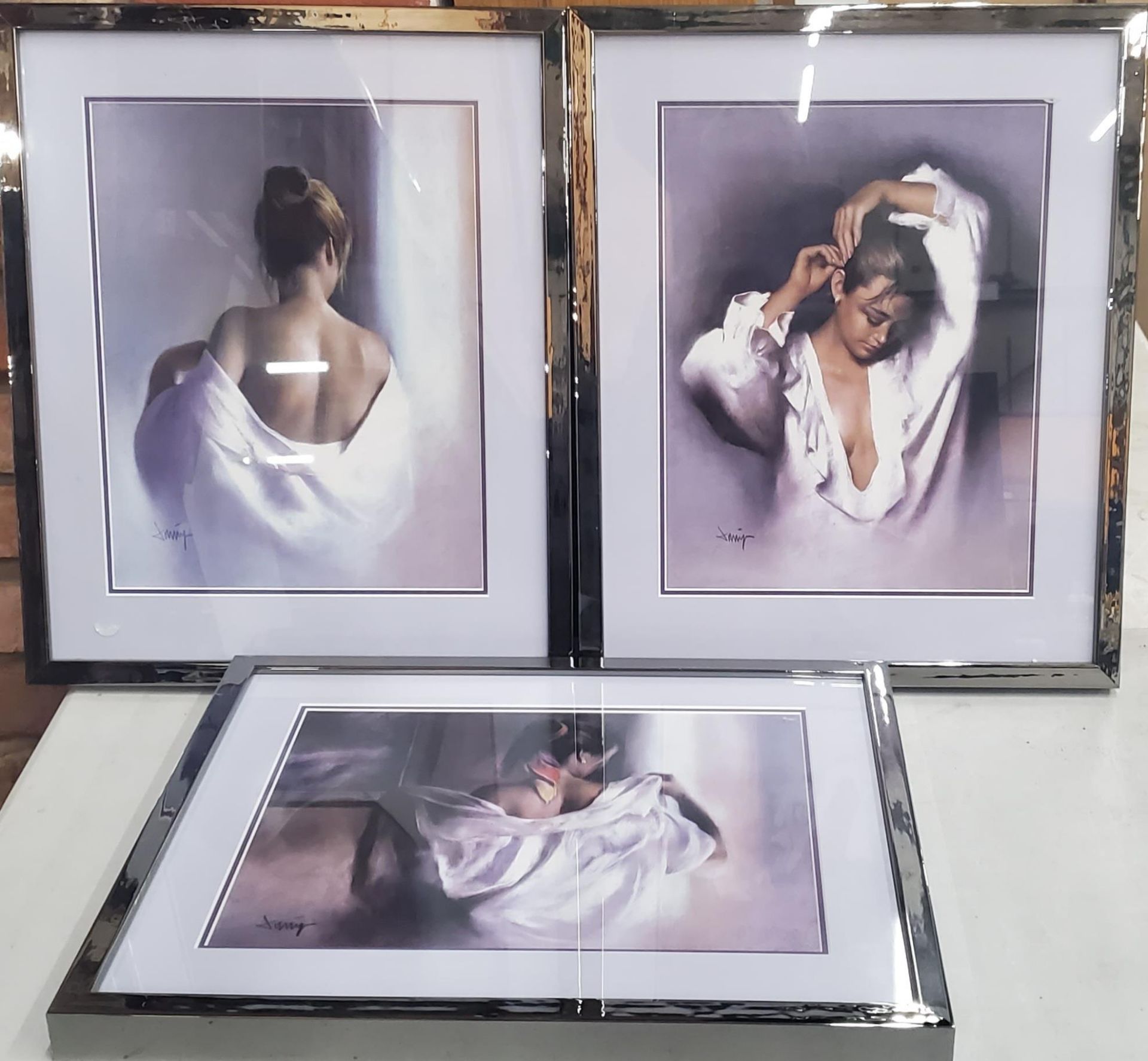 THREE SILVER EFFECT FRAMED MODERN PRINTS OF A LADY, SIGNED