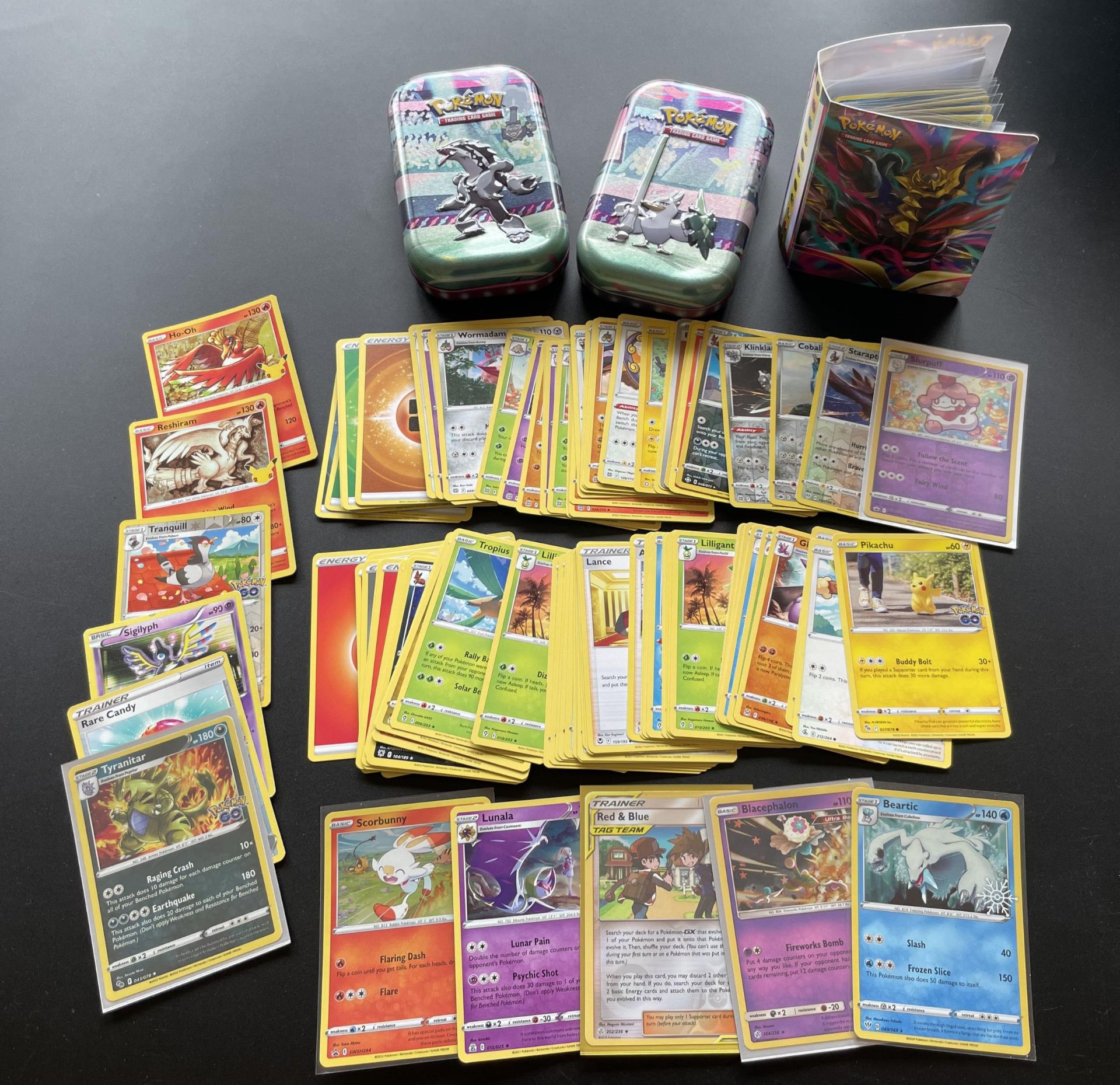 TWO TINS OF ASSORTED POKEMON CARDS, HOLOS, SMALL FOLDER OF CARDS ERC