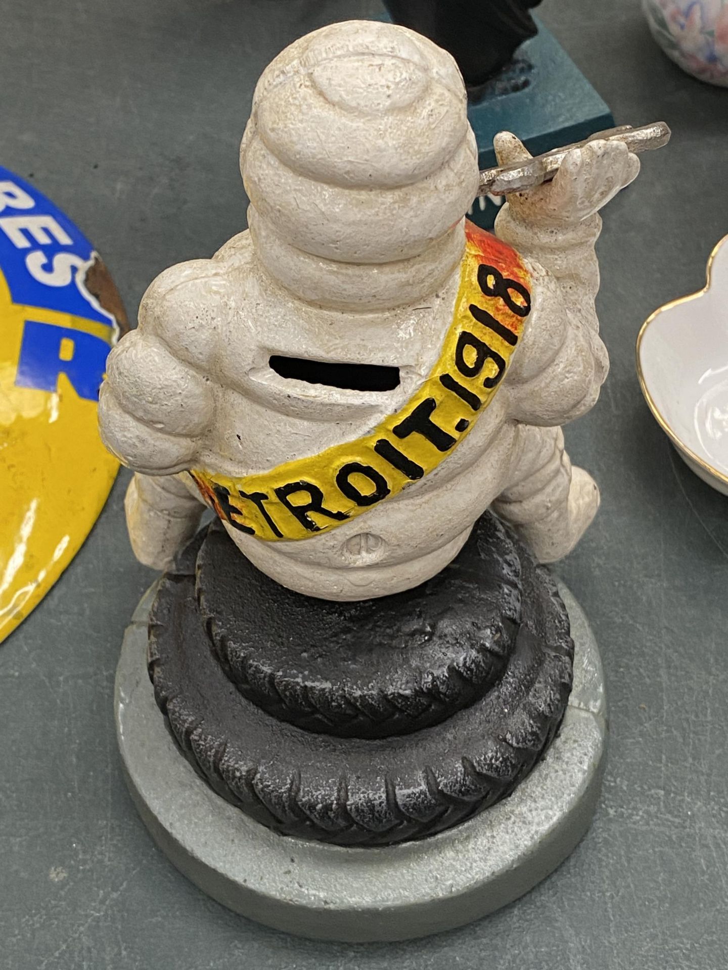 A CAST MICHELIN MAN ON A TYRE MONEY BOX, HEIGHT 19CM - Image 2 of 3