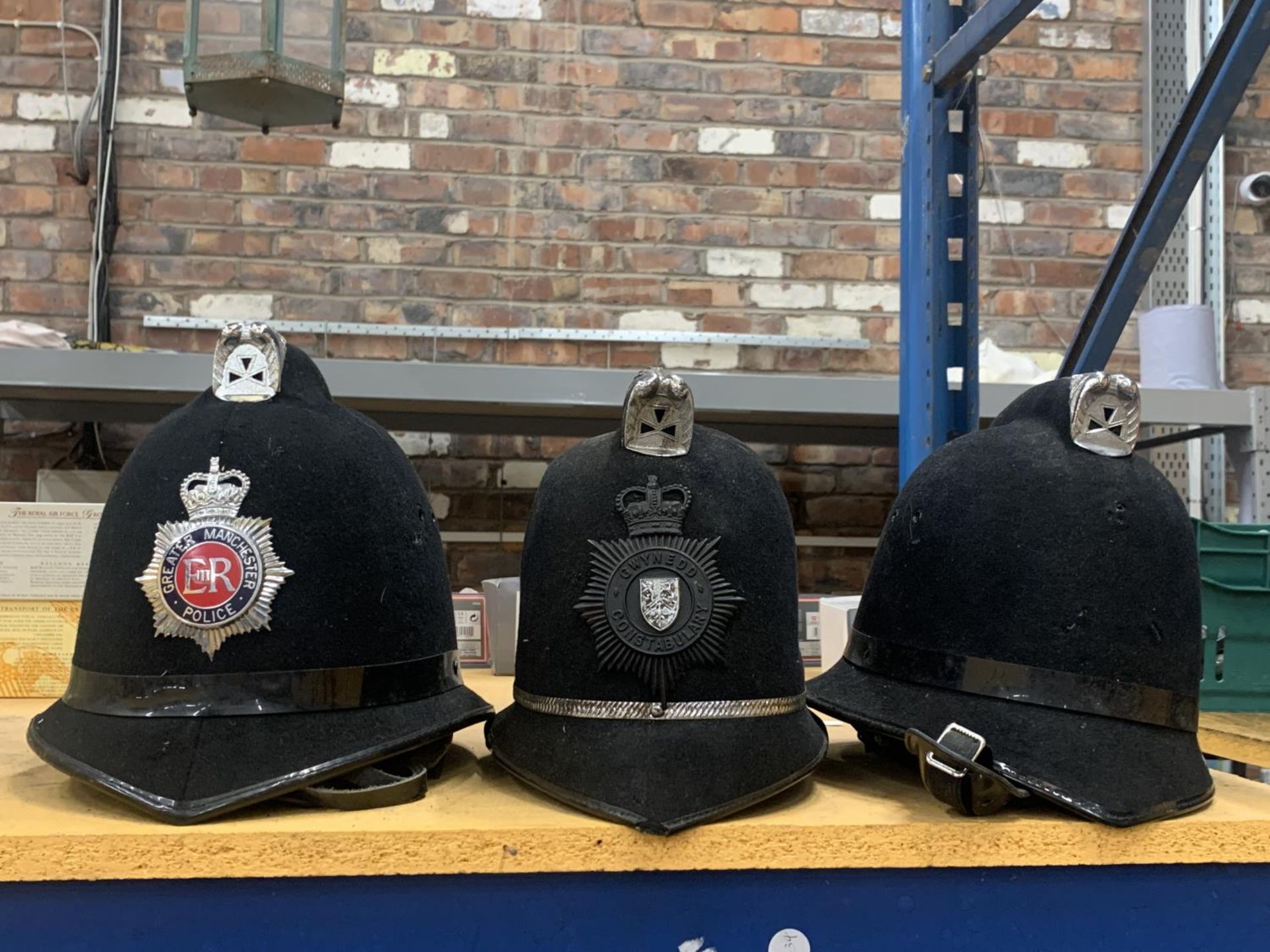 A GROUP OF THREE POLICEMAN HATS, GREATER MANCHESTER ETC