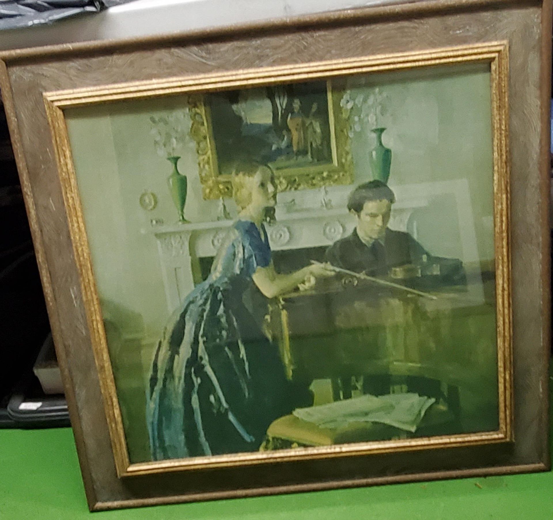 A FRAMED PRINT OF A MAN PLAYING THE PIANO WITH A LADY