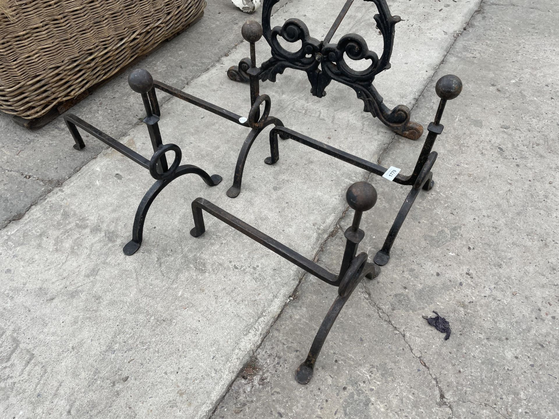 A SET OF FOUR WROUGHT IRON FIRE DOGS