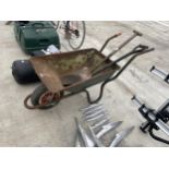 A METAL WHEEL BARROW AND TWO SHOVELS