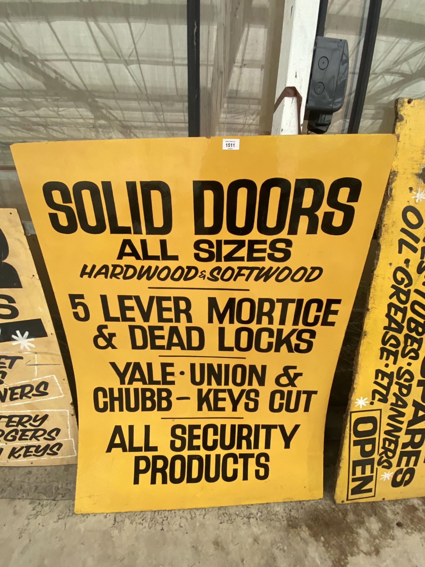 A WOODEN 'SOLID DOORS' SIGN